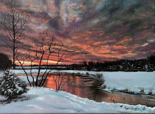 snow in sunset reflecting on water